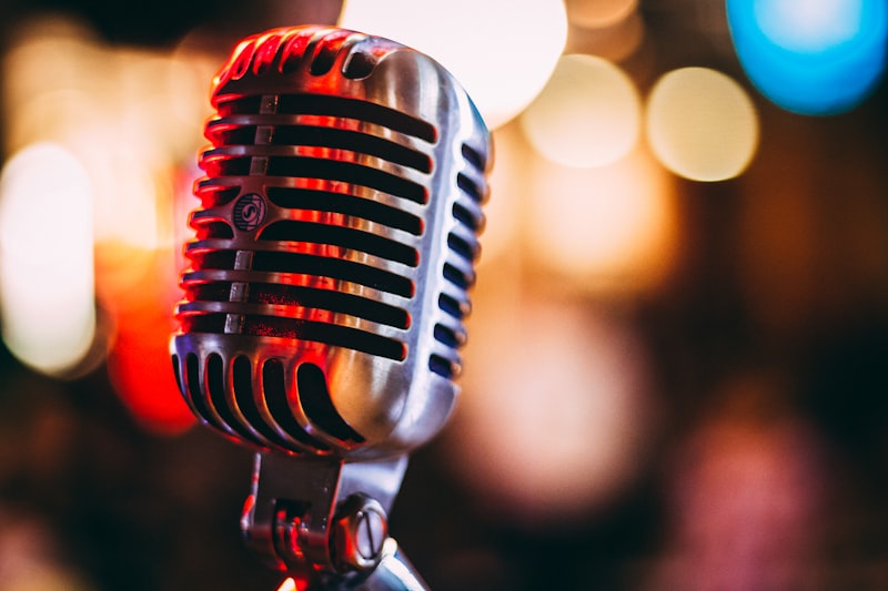 Vintage microphone with warm bokeh lights for host-read podcast ads