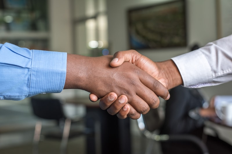 Professional business handshake closing a B2B deal