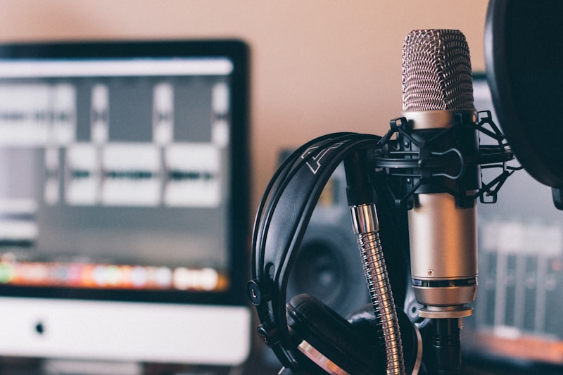 Podcast recording setup with microphone, headphones and audio software